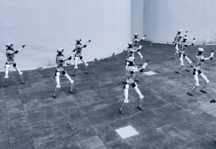 18 humanoid robots exit crates and move in sync under new AI system 18 humanoid robots exit crates and move in sync under new AI system